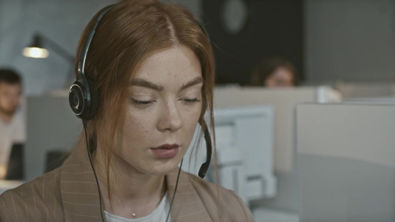 Customer support specialist speaking with a customer through a headset